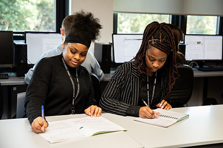 Two students working at a desk